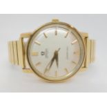 A 9CT GOLD GENTS OMEGA SEAMASTER AUTOMATIC with silvered dial with gold coloured baton numerals,