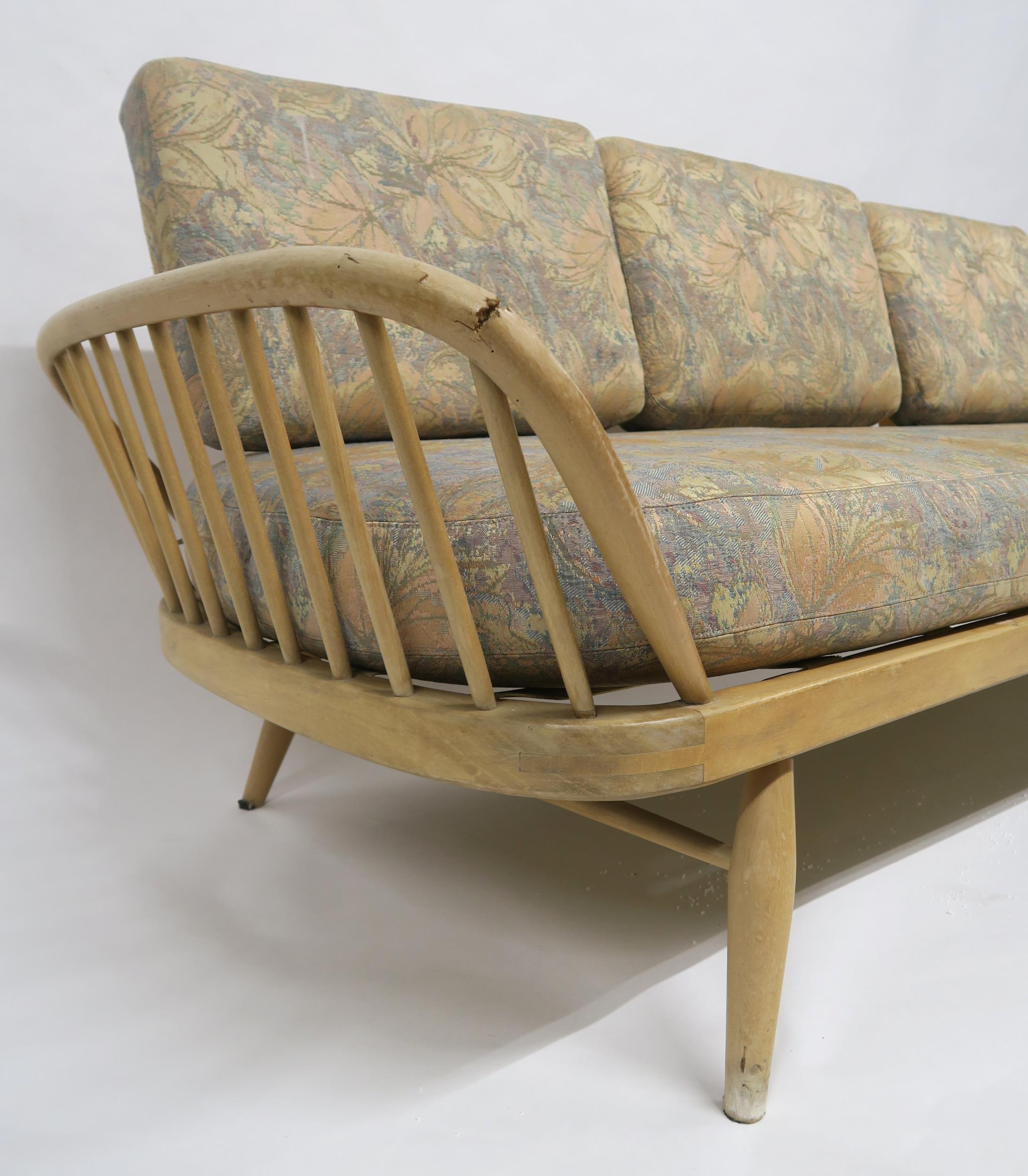 A MID 20TH CENTURY ELM AND BEECH FRAMED ERCOL DAY BED with floral upholstered cushions, 77cm high - Image 2 of 11