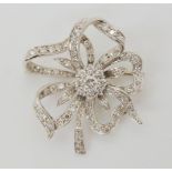 A DIAMOND FLOWER BROOCH set through out in 18ct white gold, the central diamond is estimated