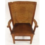 A 19TH CENTURY OAK FRAMED ORKNEY CHAIR with rushed back and shaped arms on stretchered square