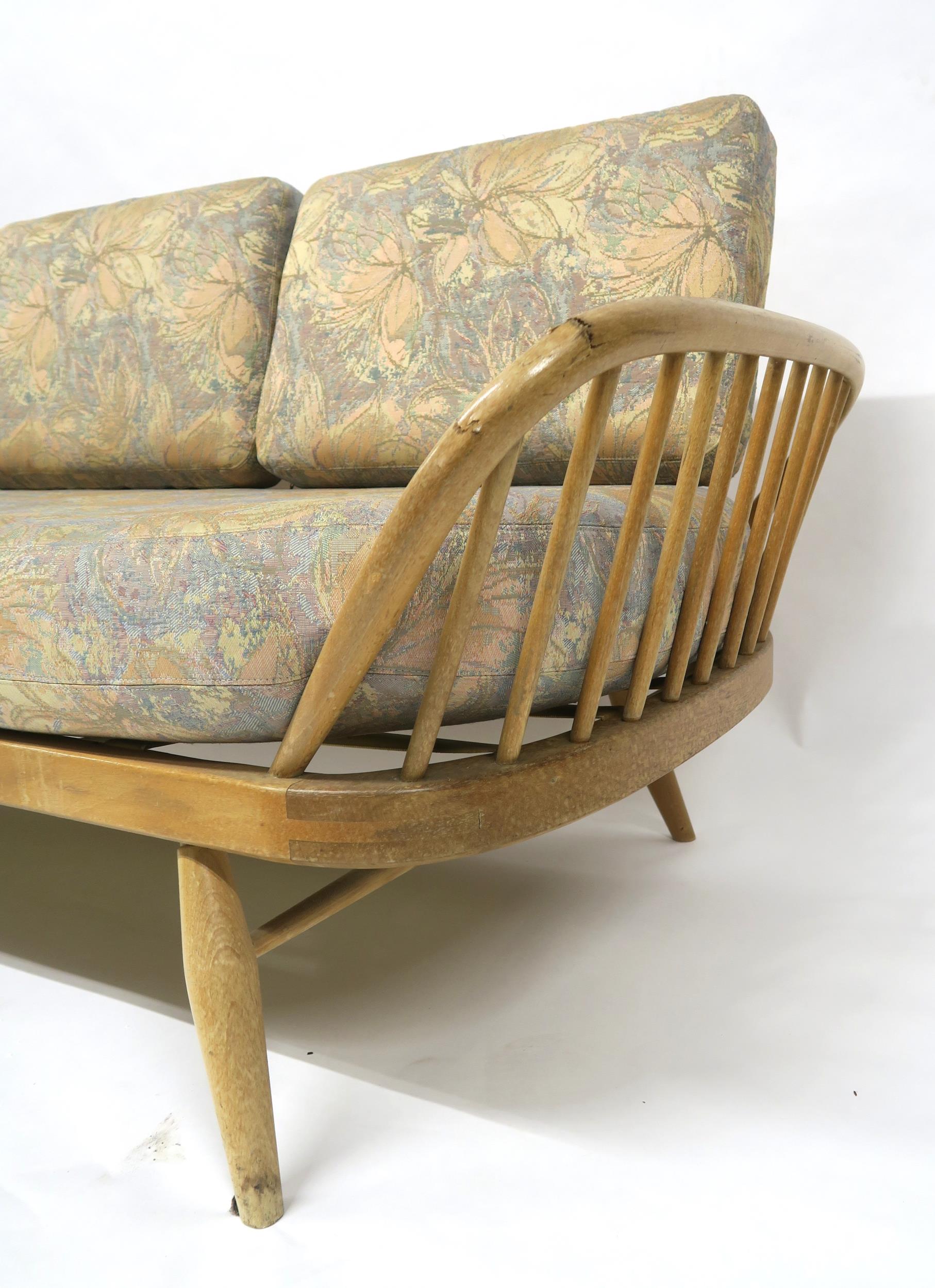 A MID 20TH CENTURY ELM AND BEECH FRAMED ERCOL DAY BED with floral upholstered cushions, 77cm high - Image 5 of 11