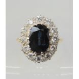 A SAPPHIRE & DIAMOND RING the classic cluster is set with a sapphire which measures approx 11mm x