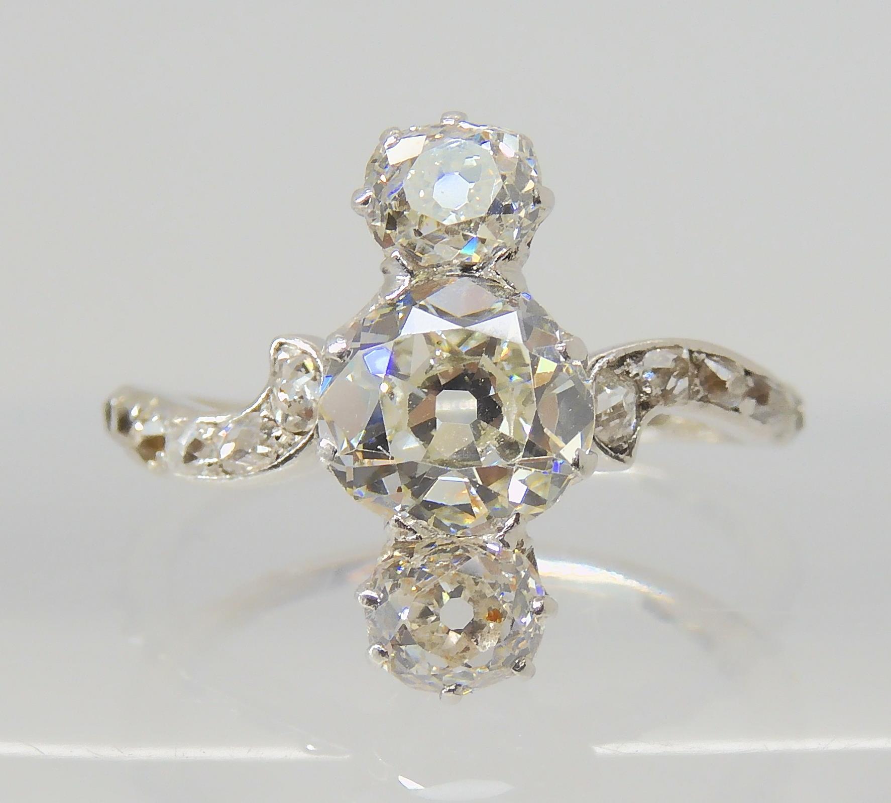 A VINTAGE THREE STONE DIAMOND RING the central old cut is estimated approximately at 0.95cts, with - Image 2 of 12