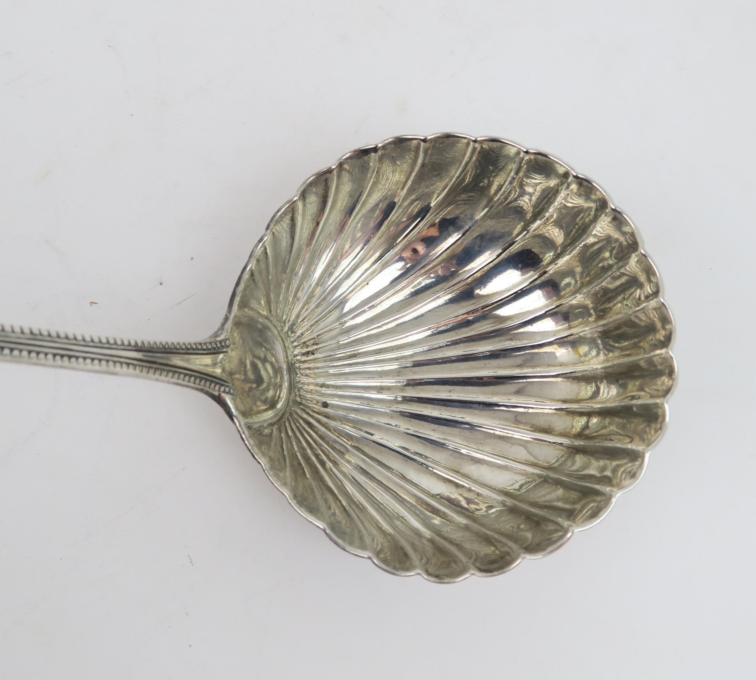 A GEORGE III SILVER SOUP LADLE in a beaded Old English pattern, with a circular shell bowl, with - Image 3 of 4