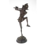 A LARGE BRONZE OF A PIXIE modelled standing on one leg playing a pipe, upon circular marble base,