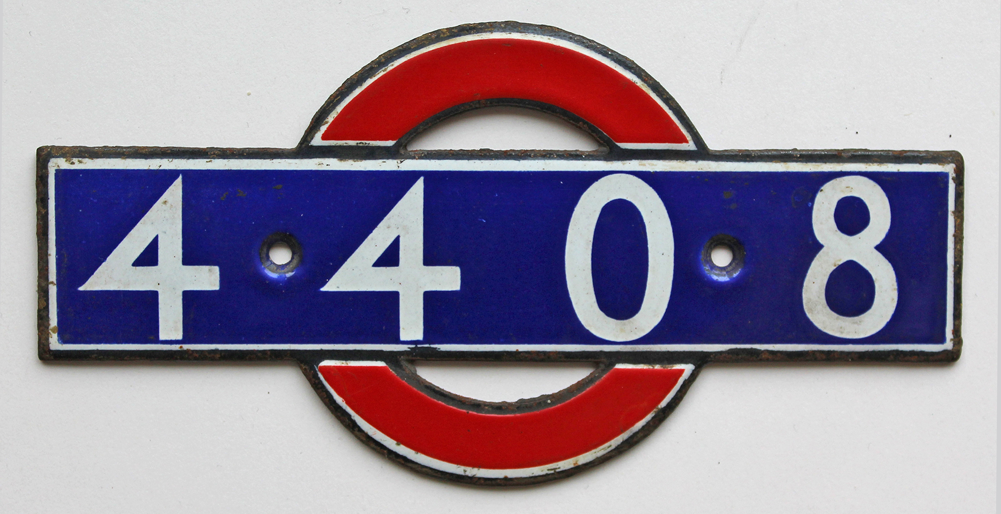London Underground enamel bullseye from driving car 4408. Measures 5.5in x 2.75in and is in very
