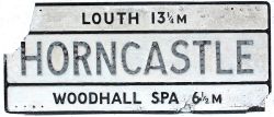Road Sign for HORNCASTLE with destination LOUTH 13.25M above and WOODHALL SPA 6.5M below. Measures