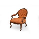 A Victorian walnut upholstered open armchair