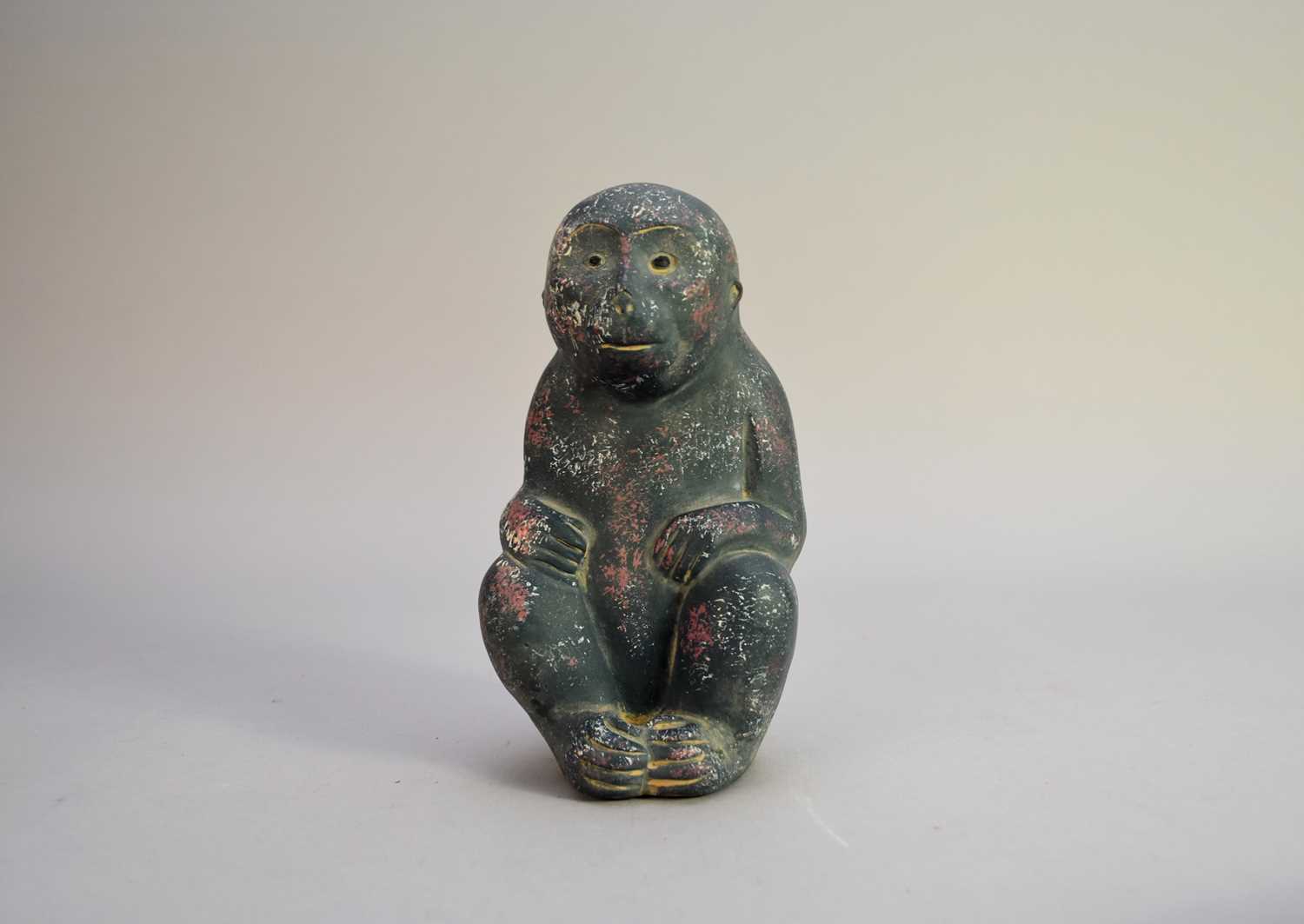 A Chinese Han style stoneware figure of a monkey