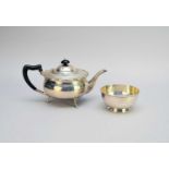 A silver teapot and associated sugar bowl