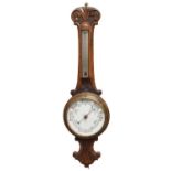 A late Victorian carved oak aneroid 'banjo' barometer