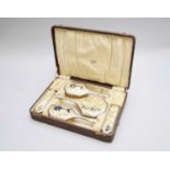An Art Deco cased silver and simulated mother of pearl mounted dressing table set