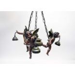 A reproduction bronze effect figural three-branch ceiling light