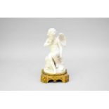 A French bisque porcelain and ormolu figure of Cupid