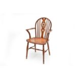 A 19th century yew and elm wheel-back Windsor armchair