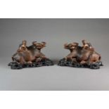 A pair of Chinese carved root wood figures of boys on buffalos