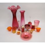 A mixed collection of cranberry and other glass to include a large vase with white frilled upper