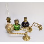Three brass oil lamp wall sconces with glass lamp fittings