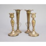 A pair of silver mounted posy vases and a pair of silver mounted candlesticks