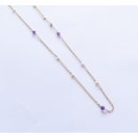 A 9ct gold seed pearl and amethyst set guard chain