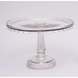 A tall press-moulded glass cakestand