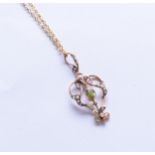 An early 20th century peridot and seed pearl openwork pendant