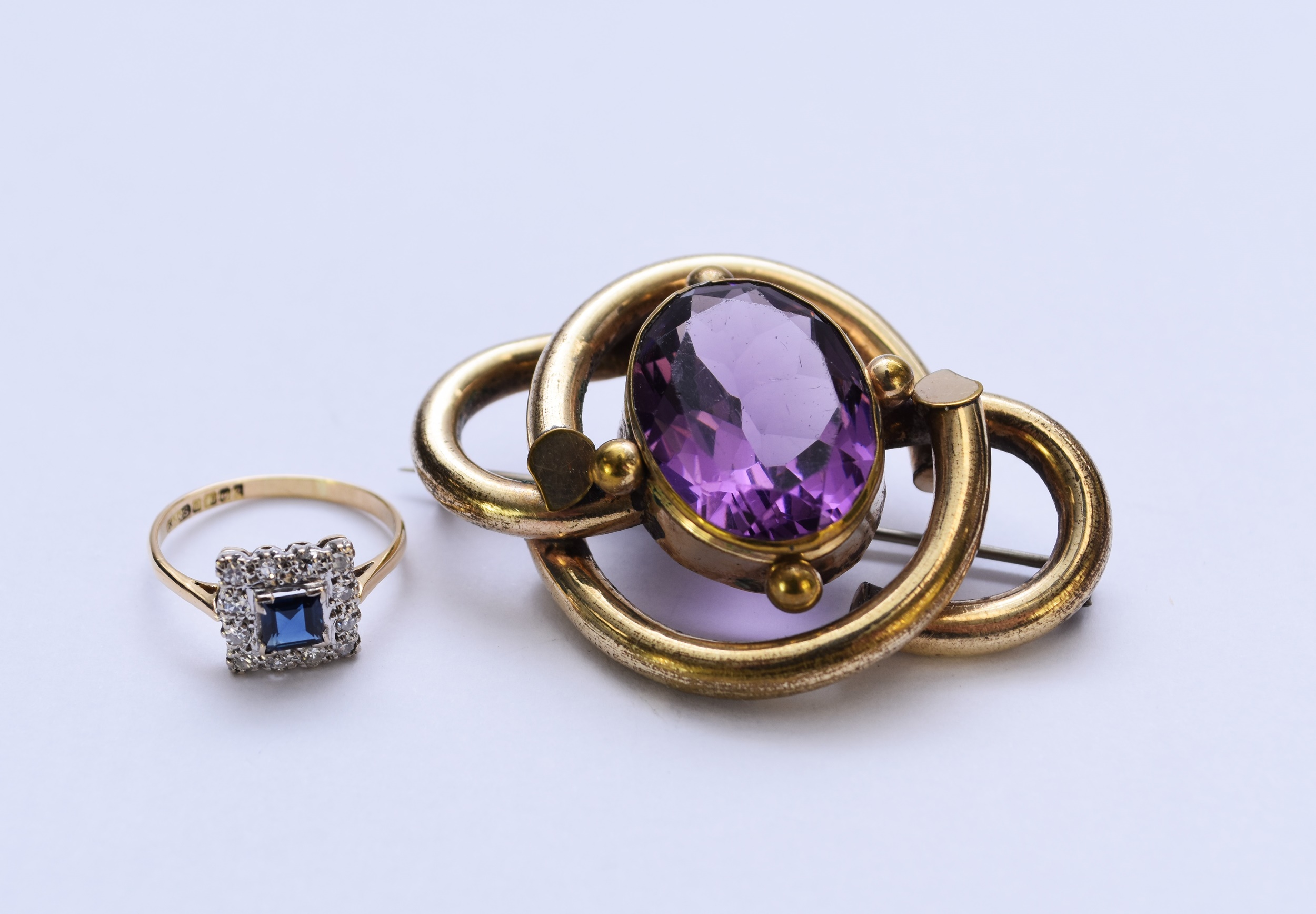 An 18ct gold sapphire and diamond ring and a paste brooch