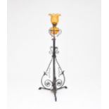 A wrought iron and amber glass oil lamp standard