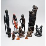 A collection of African earthenware and wood tribal figures and a totem