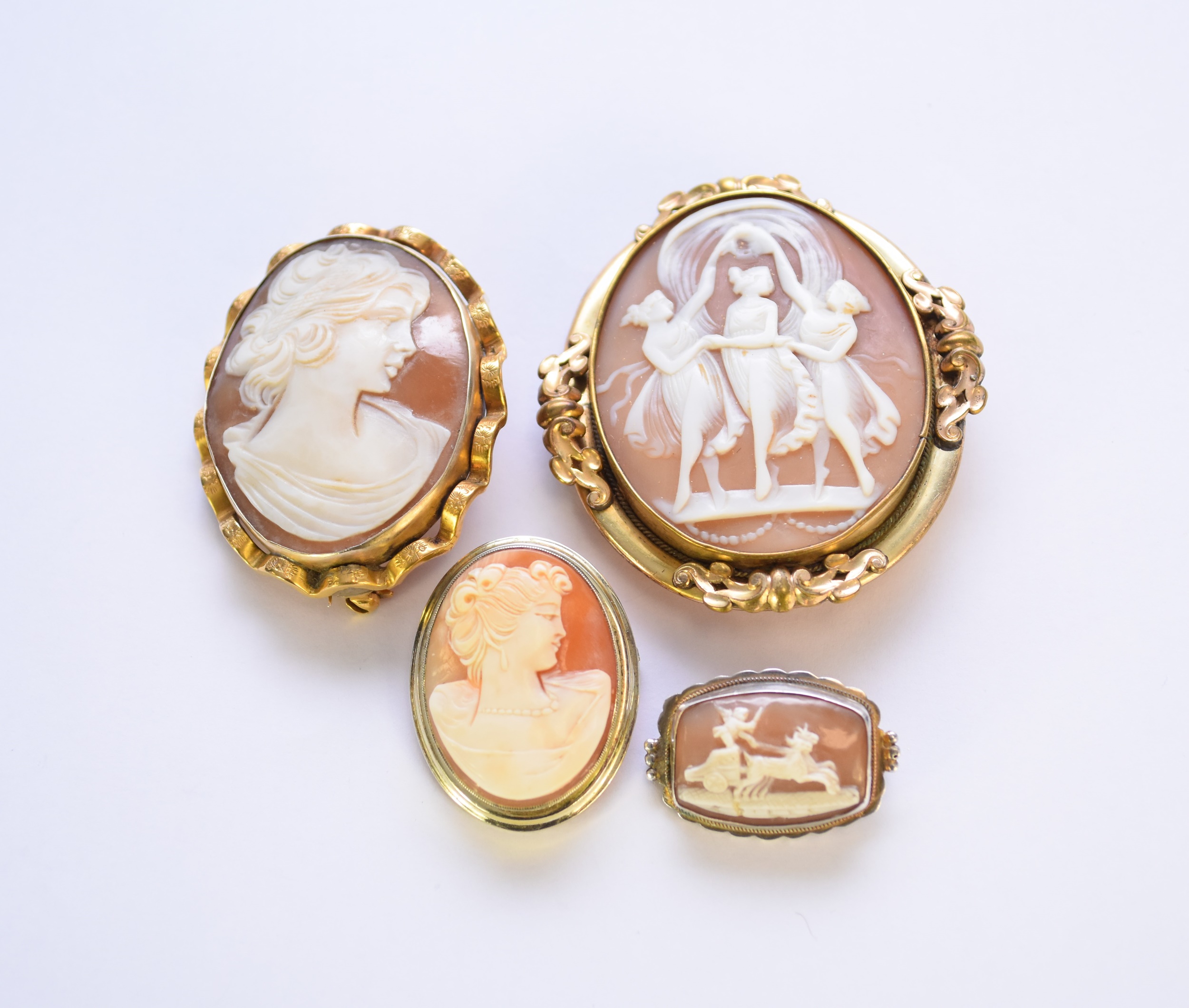 A collection of four cameo brooches
