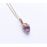 A heart shaped amethyst and seed pearl set pendant