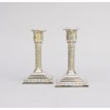 A pair of Victorian silver mounted candlesticks