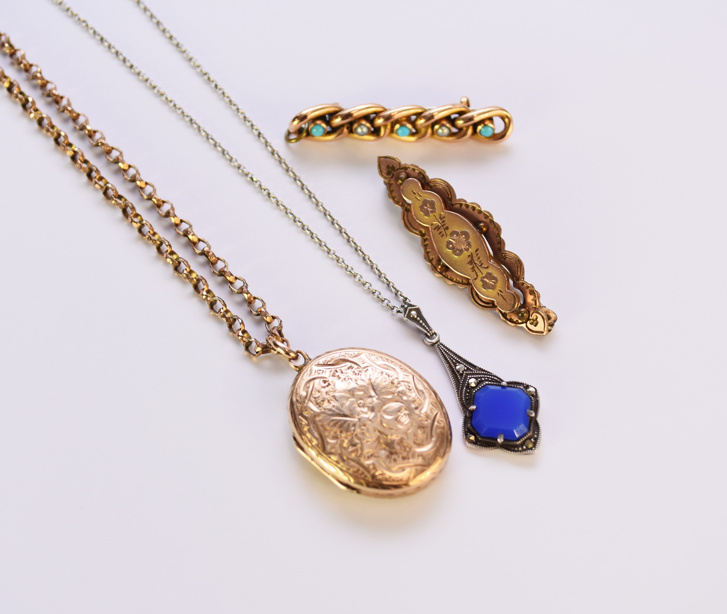 Two brooches, a locket and a pendant on chain