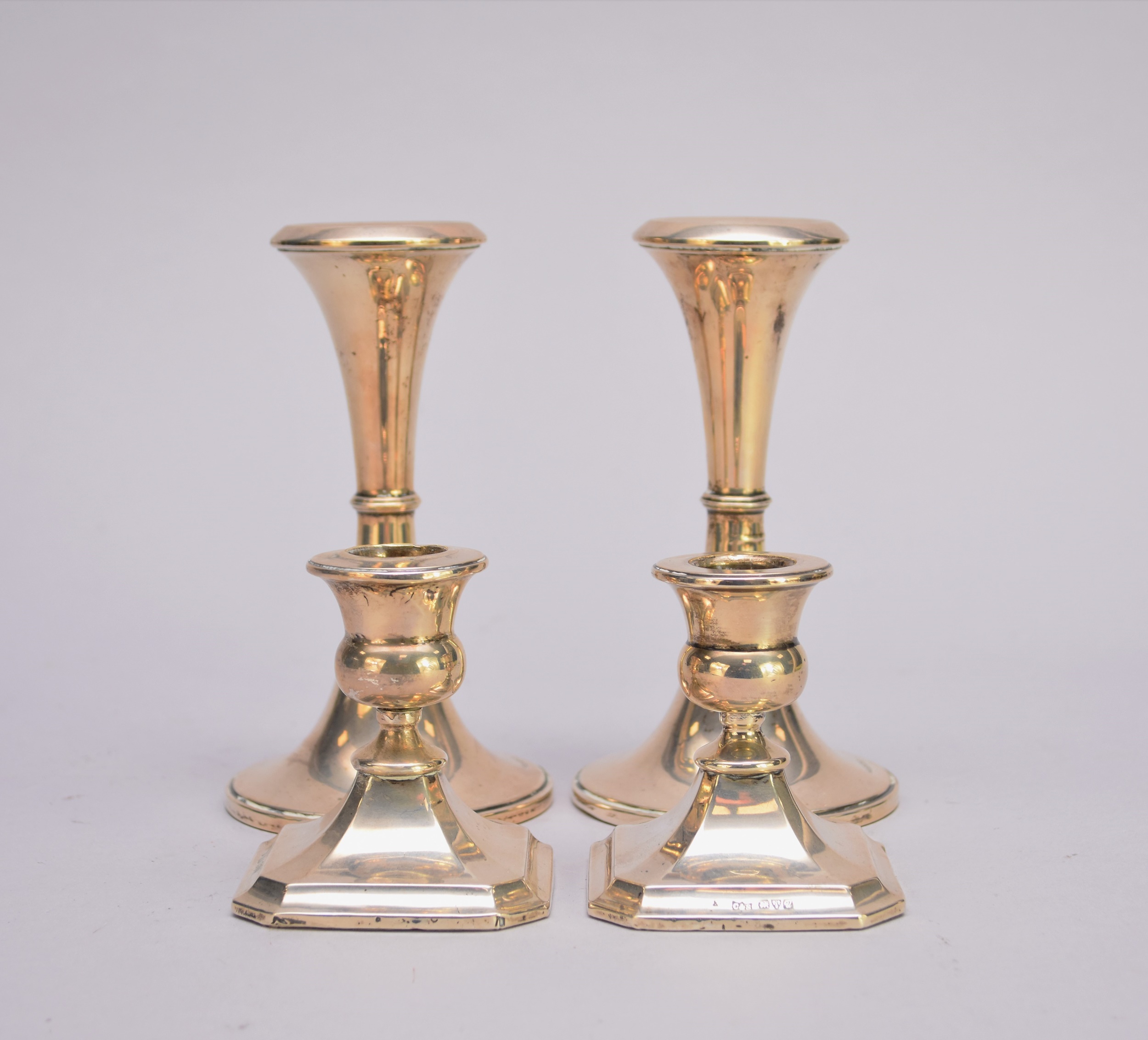 Two pairs of silver mounted candlesticks