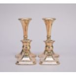 Two pairs of silver mounted candlesticks