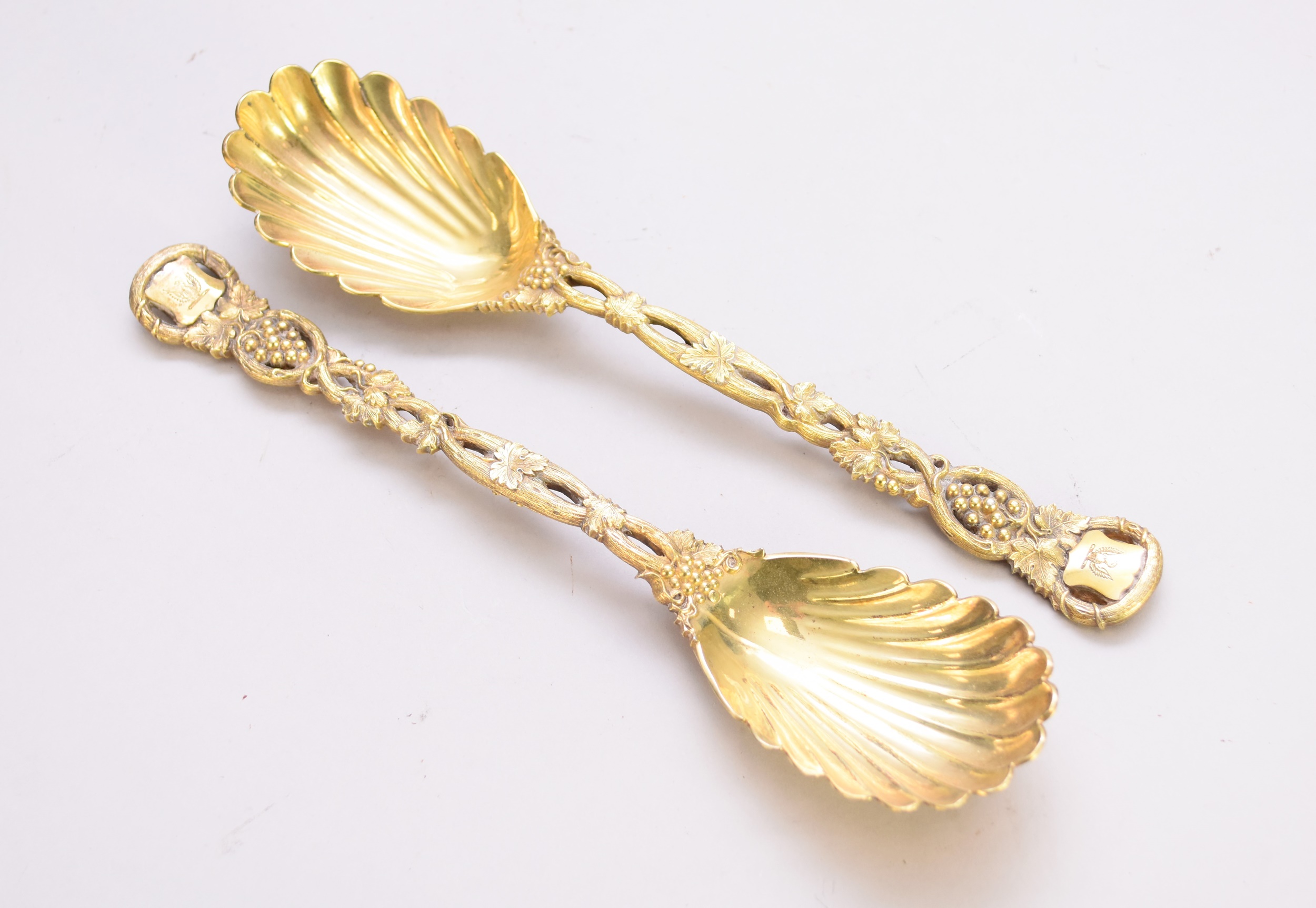 A pair of Victorian silver gilt 'Pierced Vine' pattern serving spoons by Hunt & Roskell