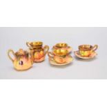 A miniature tea service painted with fruit