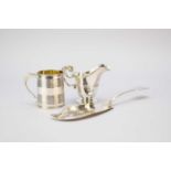 A silver mug, silver cream jug and silver fish slice