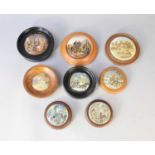 Eight framed prattware pot lids including 'Hunting Bears' and 'The Bear Pit'