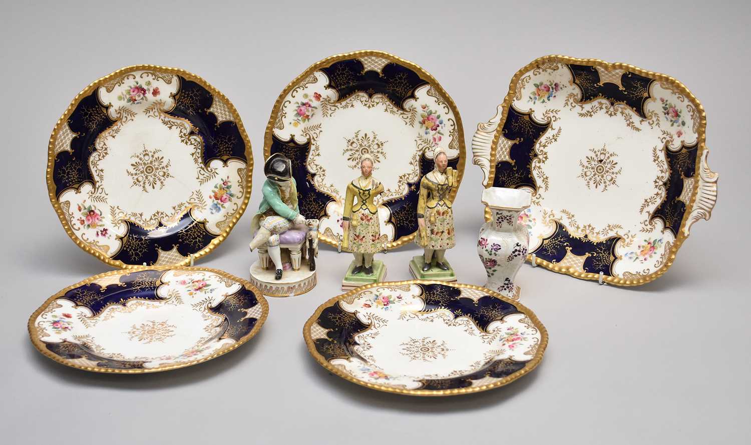 A collection of porcelain, including a Meissen model of a seated boy and Coalport batwing service