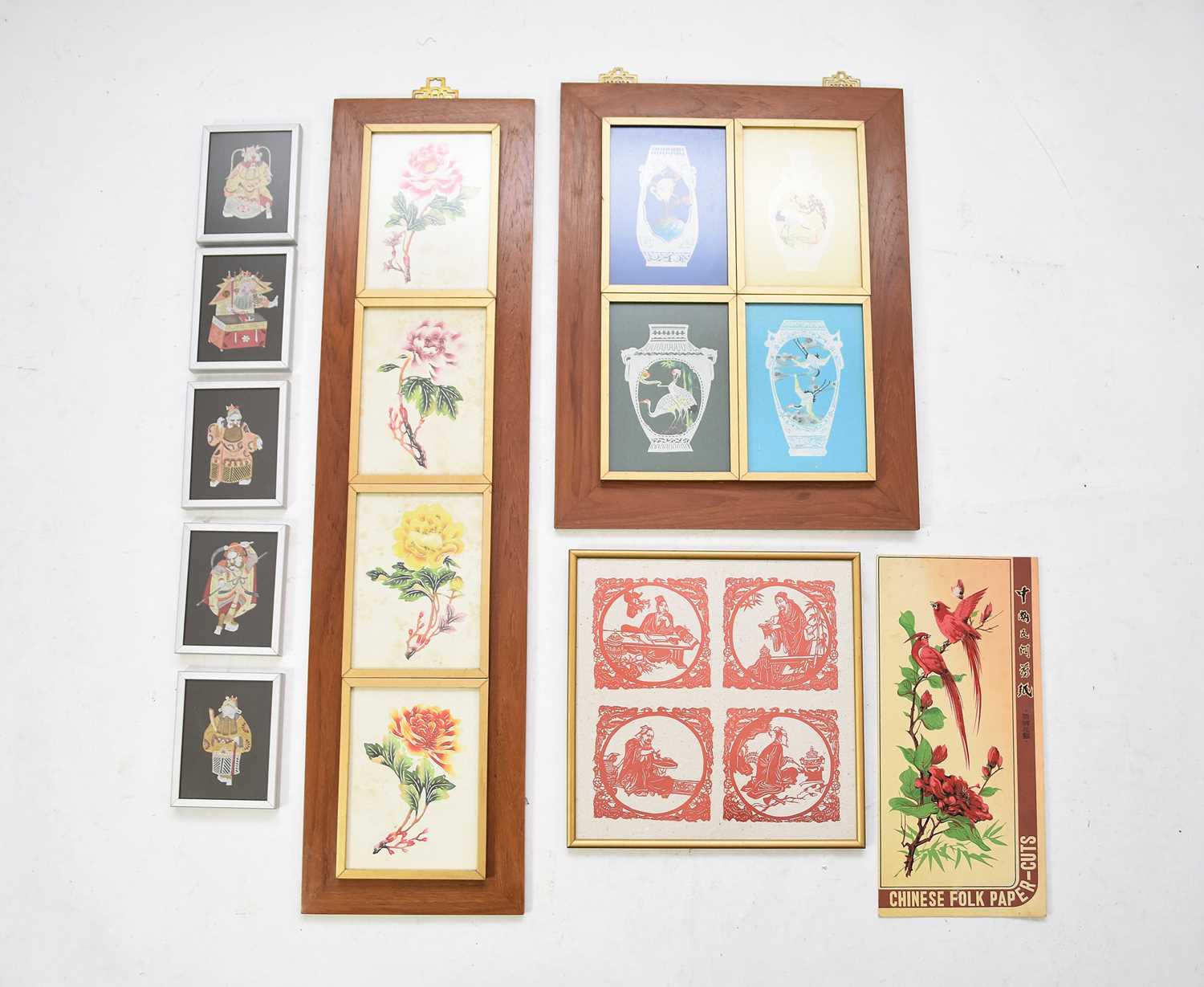 A collection of Chinese cut paper decorations including framed examples