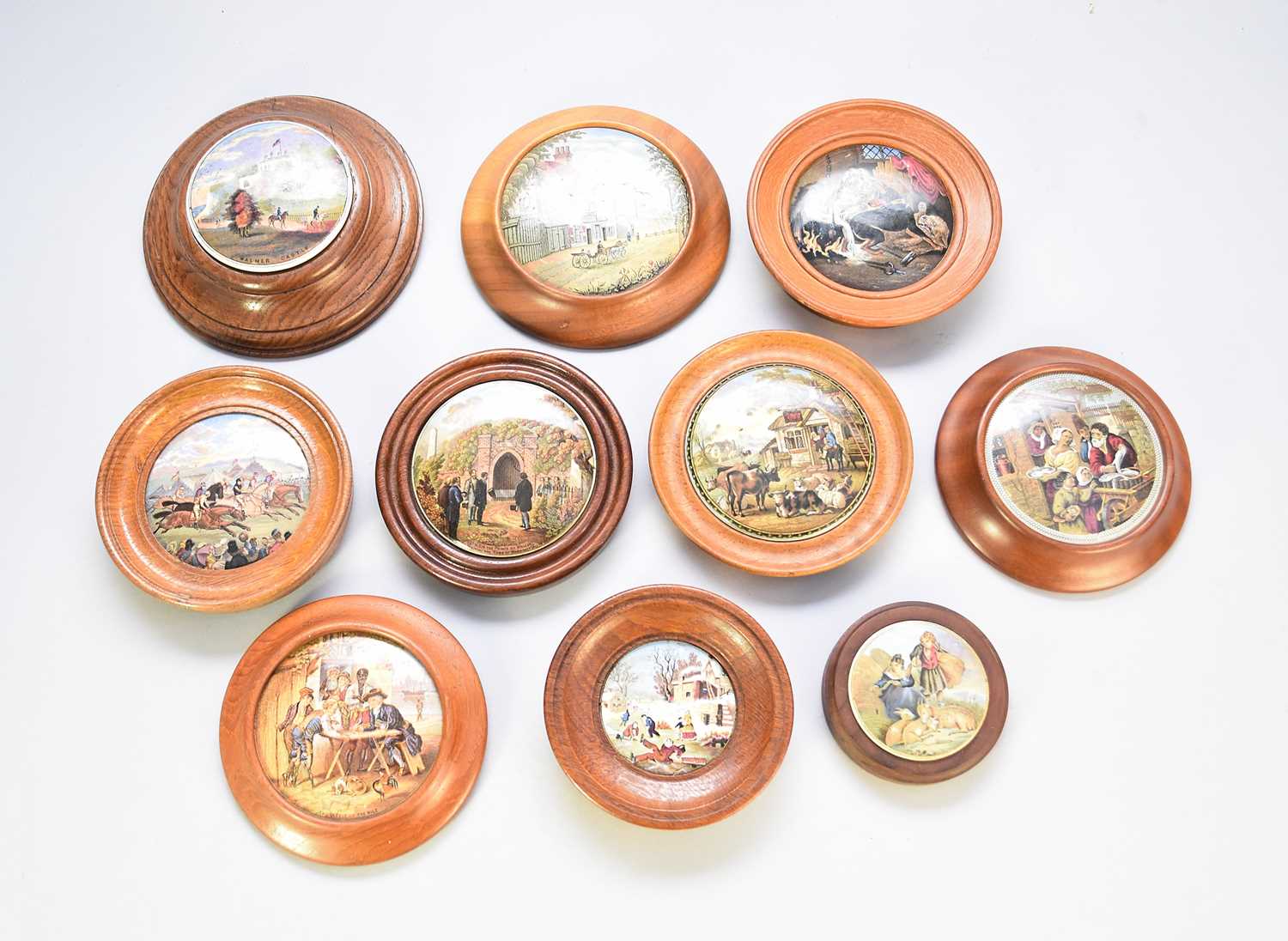 A group of framed prattware pot lids