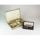 A cased silver mounted dressing table set