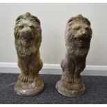 A pair of cast stone garden lions