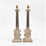 A pair of imposing silver coloured ionic column table lamps