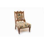 An Edwardian walnut nursing or parlour chair