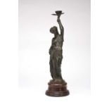 A 19th century Bronze figural candle holder