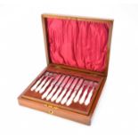 A cased set of twenty-four mother of pearl handled silver fruit knives and forks