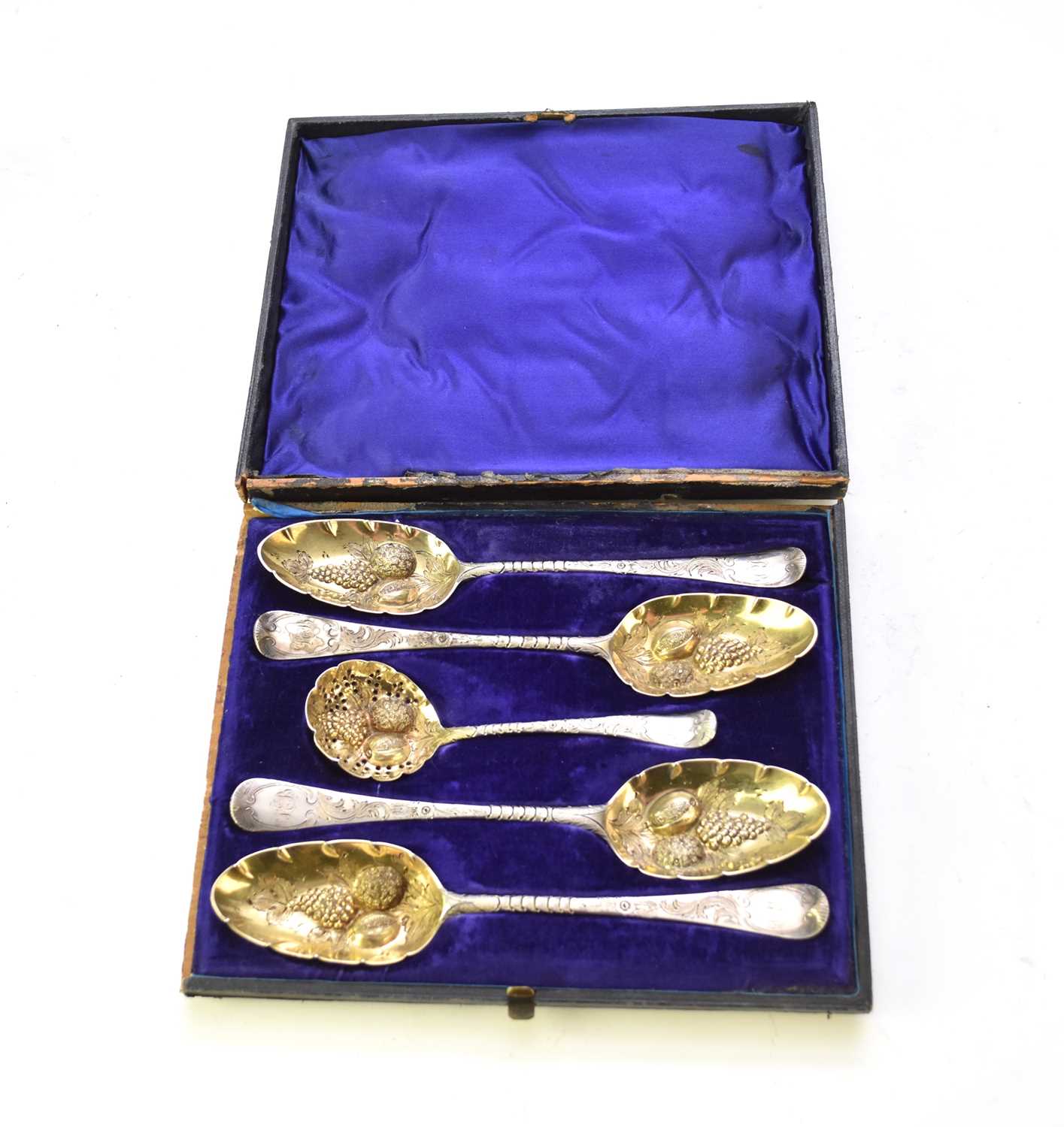 A matched set of four later embossed silver fruit spoons and sugar sifter spoon
