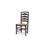 A rush seated ladder back chair and a yew wood chair